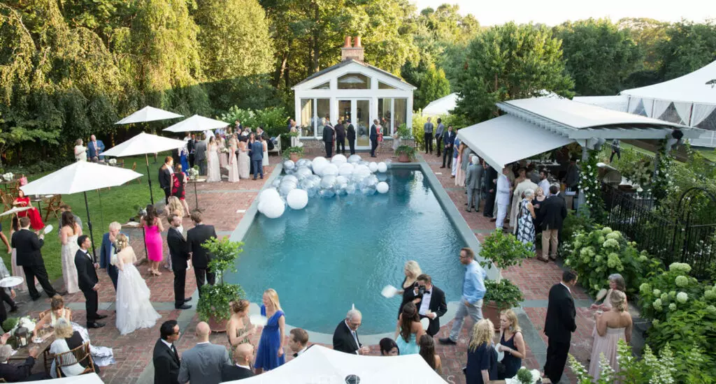 Beautiful wedding event produced by Leslie Mastin Events. Outdoor event with pool, umbrellas and balloons.