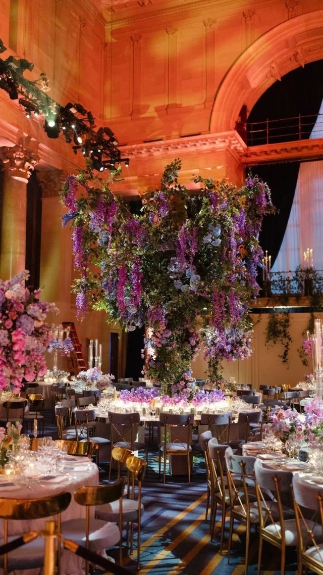 Part two… 

Moving on to dinner...
We had three custom floral bars with gold mirror countertops and shelving adorned with florals and candles. The band performed in front of a 32-foot white acrylic wall with multiple arches at heights of 8 to 12 feet, draped in greenery and florals. Marietta & Stavros were seated before a garden-inspired backdrop of tall trees with flowers and suspended glass-enclosed candles above their table. Guests gathered at two large, doughnut-shaped mirrored tables wrapped in blue velvet, featuring mirrored bronze runners, oversized crystal candlesticks, vintage map table numbers embossed in gold, letterpress-printed menus on velvet, and stunning floral centerpieces. The remaining round tables showcased crescent-shaped silver wrought iron centerpieces dressed in florals, elevated on gold mirrored risers, and complemented by ruffled specialty cloths.
 
Dessert & Coffee…
Instead of a traditional wedding cake, Marietta and Stavros chose a stunning display of Cipriani Vanilla Meringue cake. The Good Life Coffee Co. served espresso, lattes, and more, featuring the couple’s monogram, while music played from the mezzanine.
 
The evening was filled with dancing, featuring traditional Greek dances and contemporary favorites, as two fantastic bands, Bravo and the Marcus Reid Band from Hank Lane Music, alternated throughout the night.
 
When the clock struck midnight, Bravo’s DJ Alex took over, with confetti blasts and introducing lounge furniture to enhance the dance floor’s vibrant atmosphere. The after-party snacks were delicious! I reunited with Aj from Katz’s Deli, who reminded me I was the first planner to organize an off-site after-party at this venue over ten years ago, which was a huge hit! We also had Chick-fil-A nuggets and 300 White Castle burgers, ensuring no one left hungry!
 
Guests departed with a boxed Baccarat candles and sugared almonds, known as koufeta, given as symbols of the couple’s future happiness and unity.
 
It was a beautiful evening of celebration with a family we absolutely love. Congrats to Marietta & Stavros!
 
(Vendor list in comment section.)